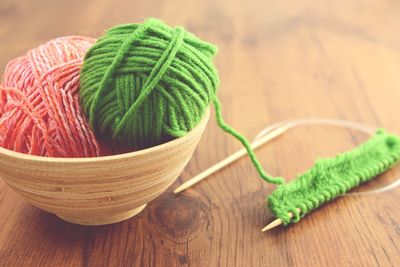 Close-up of knitting needle and wool on table