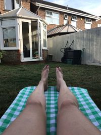 Low section of person relaxing in swimming pool