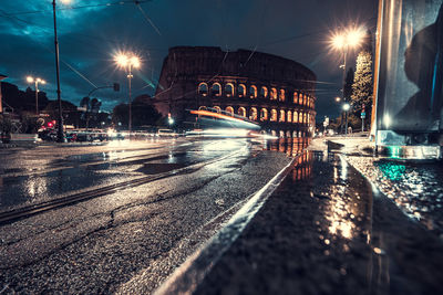 Traffic in colosseum at night. rome, italy