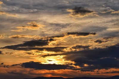Low angle view of dramatic sky during sunset