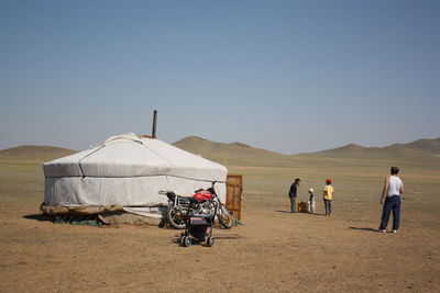 A nomadic family in the silent central asian desert.