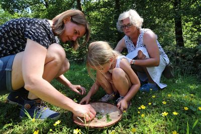 Family picking flowers on field