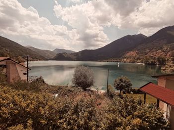 Scenic view of lake and mountains against sky