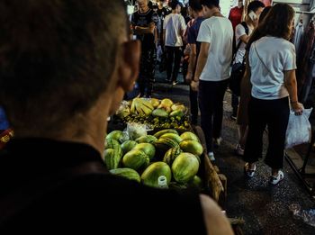 Rear view of people working in market