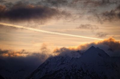 Scenic view of snowcapped mountains against sky during sunset