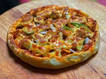 Close-up of pizza on wooden table