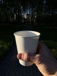 Person holding coffee cup