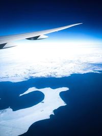 Aerial view of landscape against blue sky