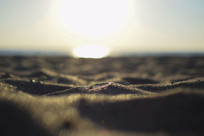 Close-up of frozen sea against sky during sunset