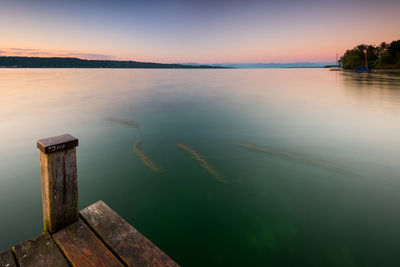 Scenic view of lake against sky during sunset