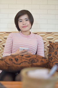 Portrait of a smiling girl sitting at home