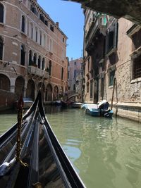 Boats in canal with buildings in background