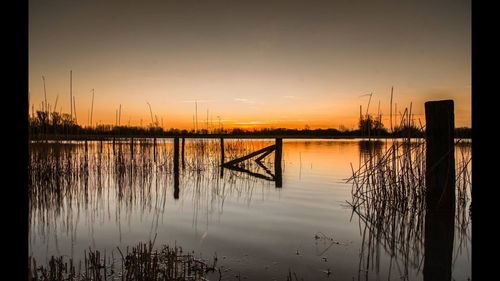 Scenic view of lake at sunset