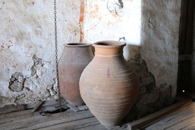 Close-up of pot on table against wall