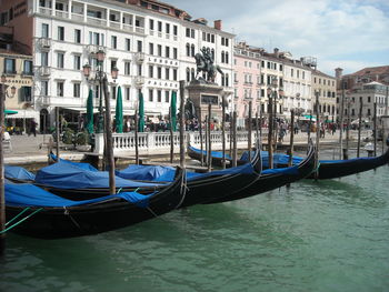 Boats in canal with buildings in background