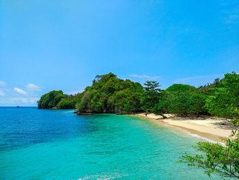 Scenic view of sea against blue sky