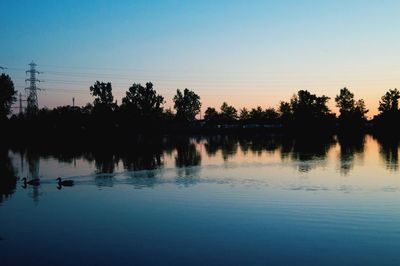 Scenic shot of calm lake at sunset