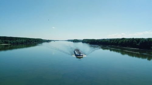 Scenic view of lake against clear blue sky