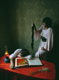 Young woman sitting on table