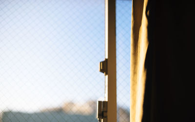 Close-up of chainlink fence against sky