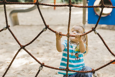 Girl holding rope in playground