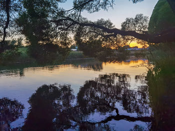 Scenic view of lake against sky during sunset