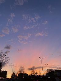 Low angle view of silhouette street against sky at sunset