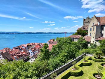 High angle view of buildings and sea against sky