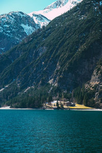 Scenic view of sea and mountains against sky