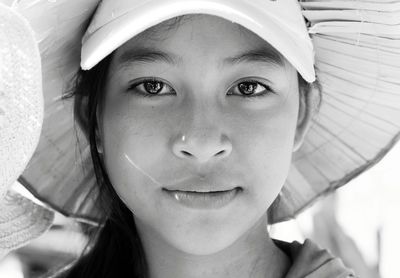 Portrait of young woman wearing hat standing outdoors