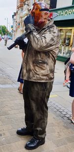 Portrait of woman standing on street in city