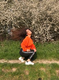 Full length of woman sitting on field