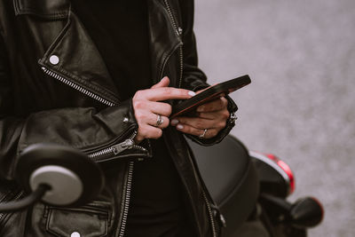 Midsection of woman using mobile phone