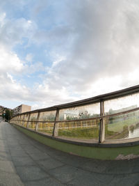 Empty road in city against sky