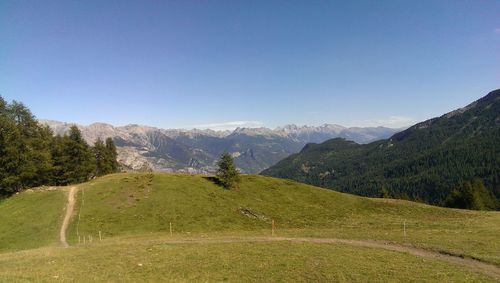 Scenic view of mountains against clear blue sky