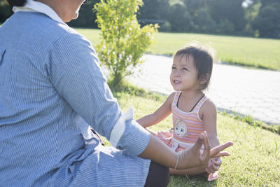 Portrait of young woman sitting on field