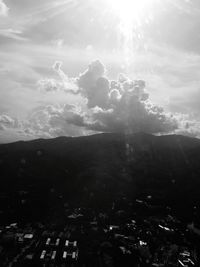 Scenic view of mountains against cloudy sky