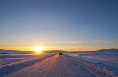 View of road on snow covered landscape