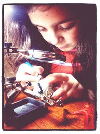 Close-up of woman holding camera