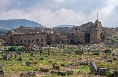 Old ruin buildings against cloudy sky