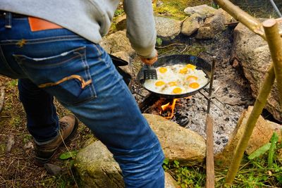 Low section of man standing by food