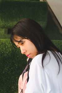 Portrait of woman standing by grass