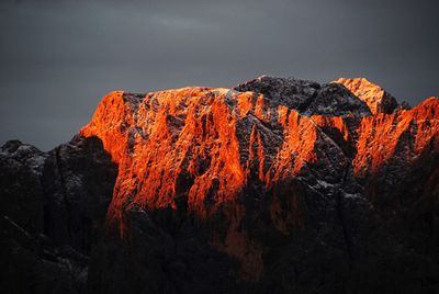 Low angle view of rocks on mountain against sky