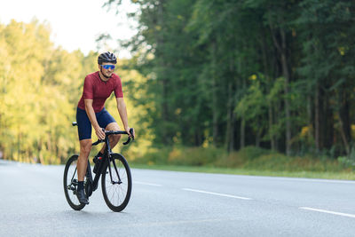 Man riding bicycle on road