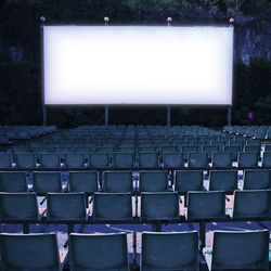 Empty chairs against projection screen