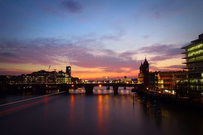 Bridge over river with city in background