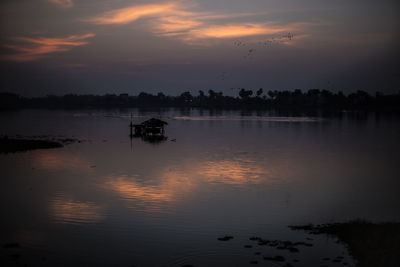 Scenic view of lake against sky during sunset