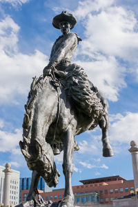 Low angle view of statue against sky in city