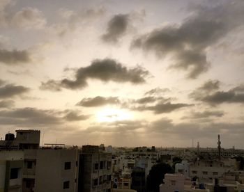 Buildings against cloudy sky