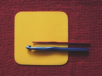 High angle view of yellow and knife on table